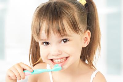 little girl brushing her teeth