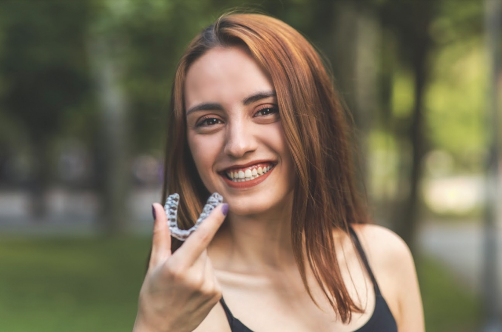 Woman showing off clear aligners in anderson sc