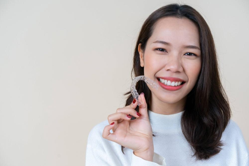 woman holding clear aligners from her Anderson SC dentist