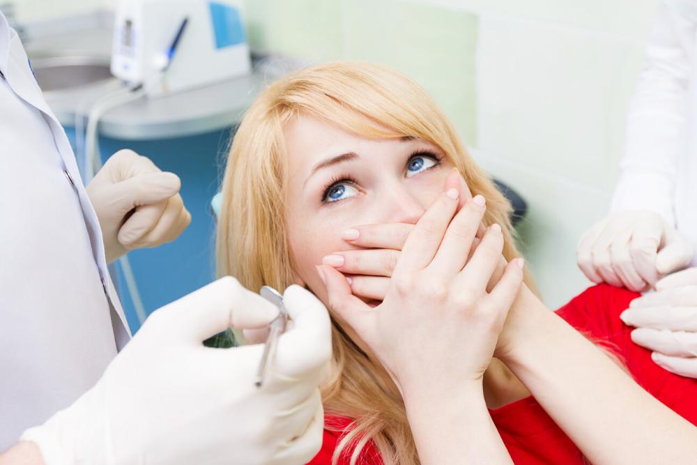 anderson woman holding hands over mouth from dental anxiety
