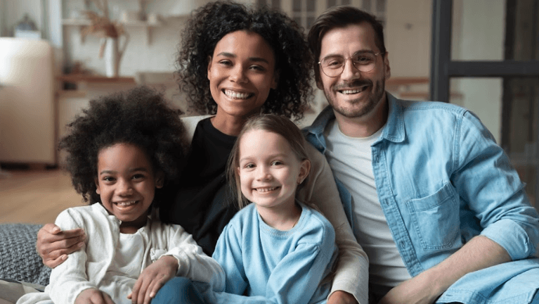 mom, dad, and two children smiling