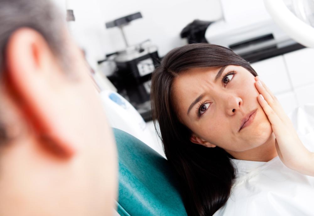 woman holding jaw from pain
