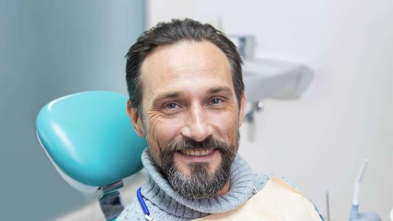 man smiling after getting dental implants in Anderson SC