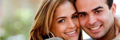 anderson man and woman resting heads together while smiling at camera