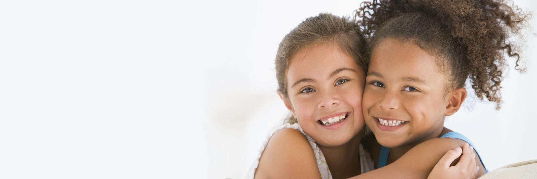 two young girls smiling and hugging in anderson sc